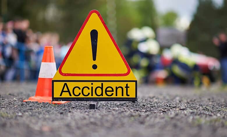 Warning sign with exclamation mark and cones at accident site in Hyderabad.