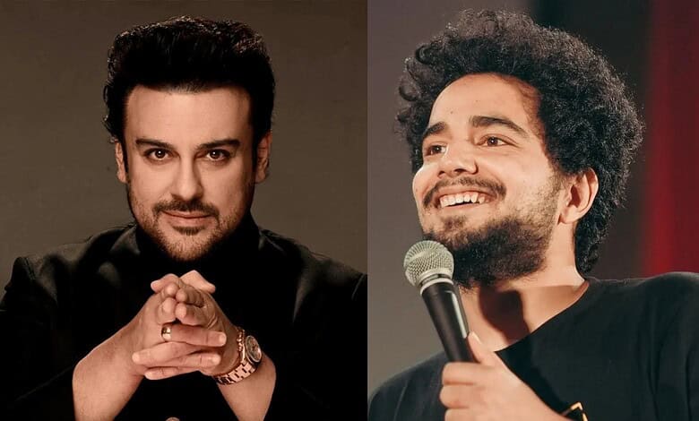 Adnan Sami performing on stage with a microphone, smiling and engaging the audience.