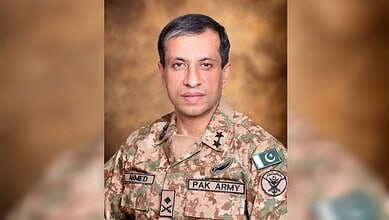 Pakistani military officer in uniform with Pakistan and military insignia.