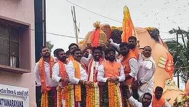 People celebrating with a large Ganesh idol during the Laddu auction event in Hyderabad.