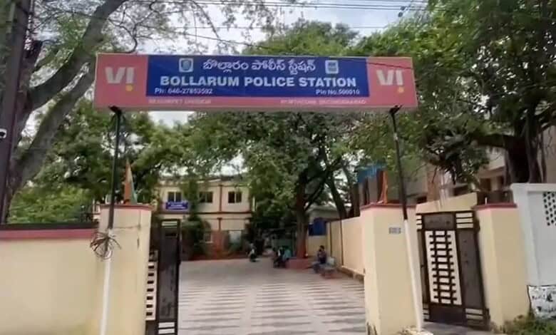 Bollarum Police Station signboard in Secunderabad, India, with trees and buildings nearby.