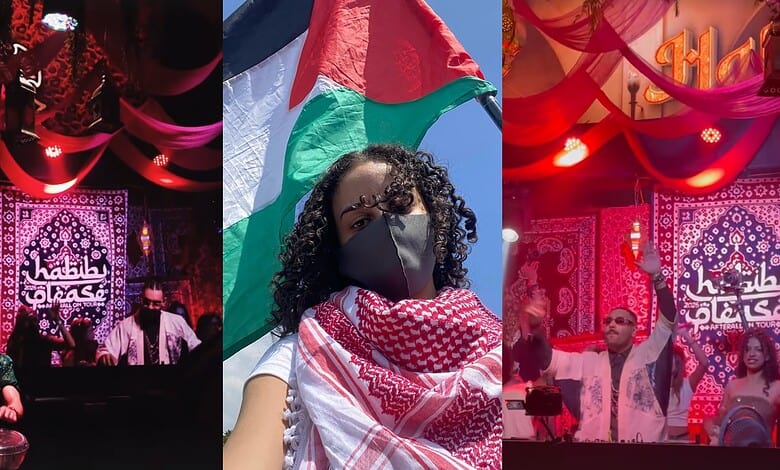 Palestinian flag held by a woman wearing a face mask at a public event.