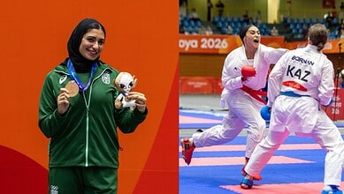 Saudi woman athlete celebrating her medal at the Asian Games in karate.