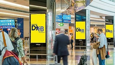 Digital signage at Dubai airport showing duty suspension extension details.