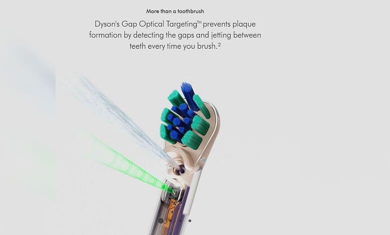 Dyson electric toothbrush with green and blue bristles and laser light for teeth cleaning.