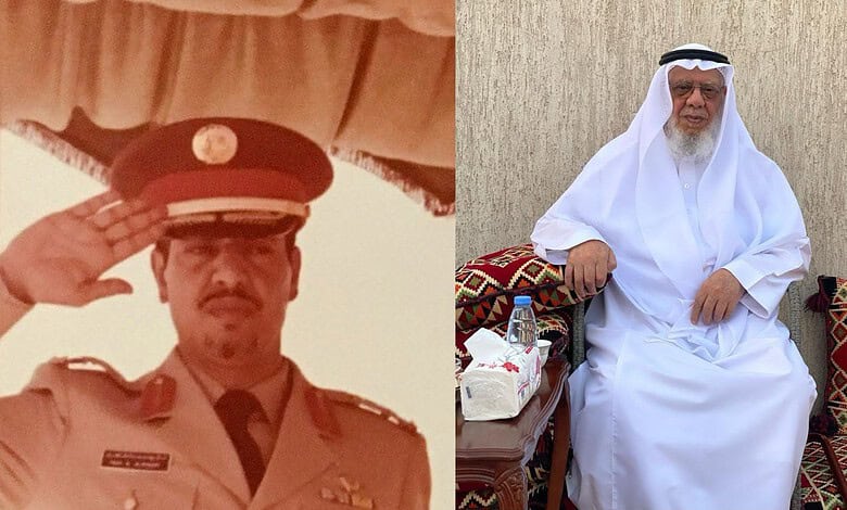 Saudi man in white thobe and head covering sitting on decorated cushions.