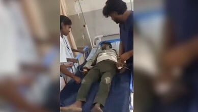 Man lying on hospital bed after clash with Ganesh idol vendors in Hyderabad.