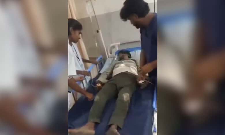 Man lying on hospital bed after clash with Ganesh idol vendors in Hyderabad.