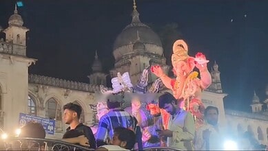 Ganesha idol during Ganesh procession at Charminar in Hyderabad, illuminated at night.
