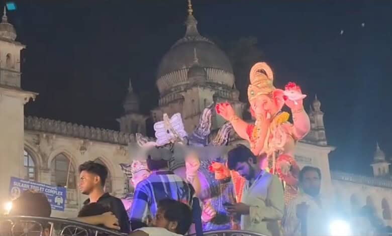 Ganesha idol during Ganesh procession at Charminar in Hyderabad, illuminated at night.