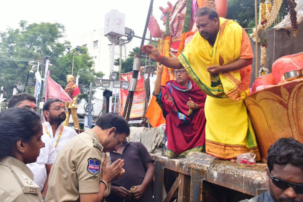 Police personnel and devotees participate in Ganesh immersion in Hyderabad.