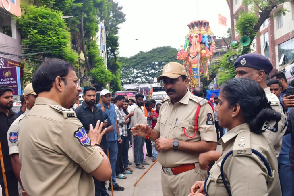 Police officers and crowd during Ganesh immersion festival in Hyderabad.
