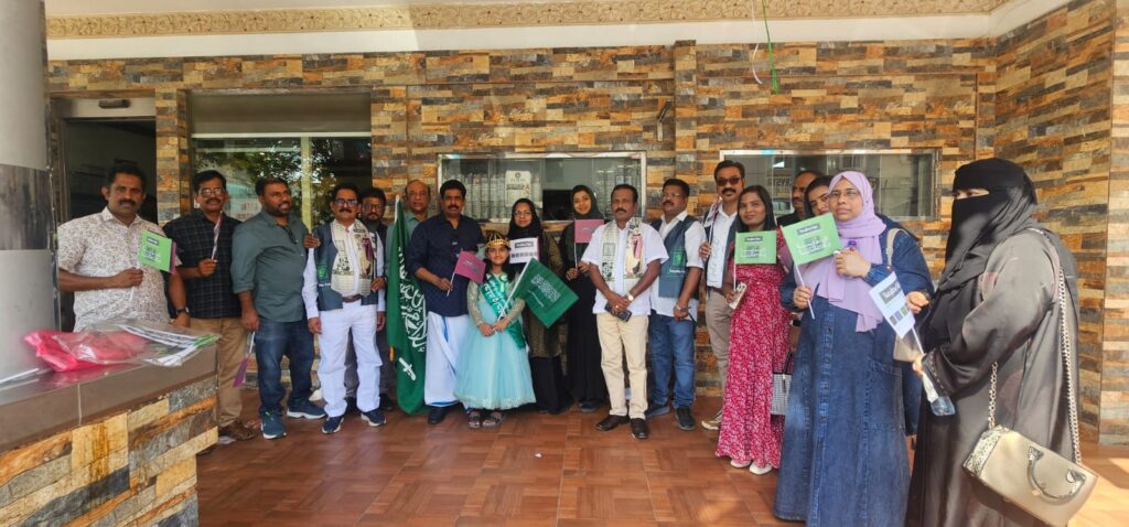 GMF members pose with Saudi flags during National Day celebrations.