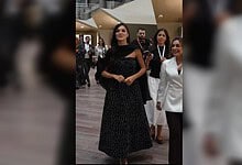 Hande Ercel in a black patterned gown at Doha exhibition.