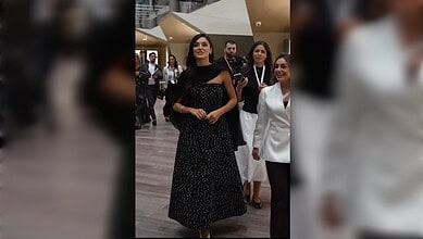 Hande Ercel in a black patterned gown at Doha exhibition.