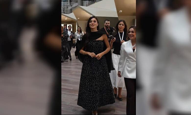 Hande Ercel in a black patterned gown at Doha exhibition.