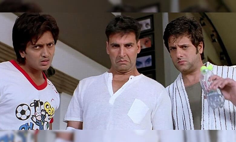 Three men with confused expressions in a home setting, one holding a water bottle.