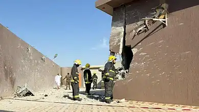 Firefighters inspect damage after Houthi drone debris caused casualties in Saudi Arabia.