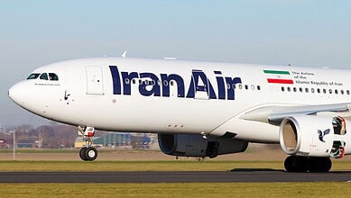 IranAir aircraft on runway with Iran flag and logo visible.