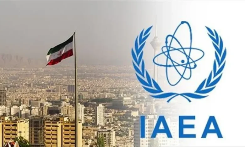 The IAEA logo and the Iranian flag fly over Tehran's cityscape in this image.