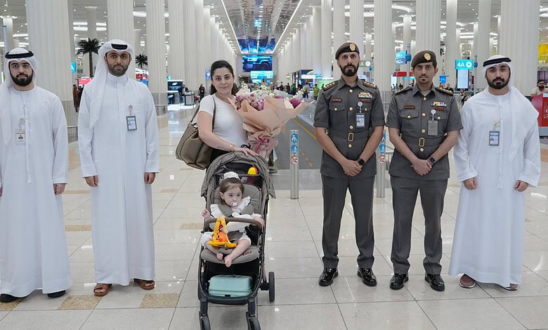 Jordanian toddler in Dubai airport with family and officials for SMA treatment.