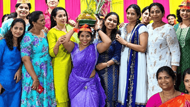 Group of women celebrating with a traditional Indian Laddu at an event in Hyderabad.
