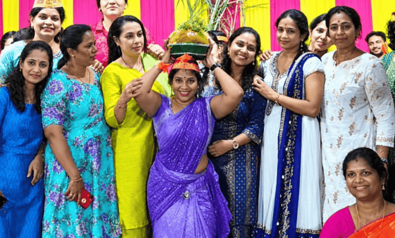 Group of women celebrating with a traditional Indian Laddu at an event in Hyderabad.