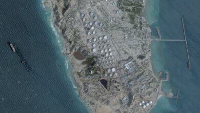Aerial view of Kharg Island oil terminal with storage tanks and port facilities in the Persian Gulf.