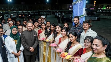 Group of Indian men and women in traditional attire during cultural celebration in Saudi Arabia.