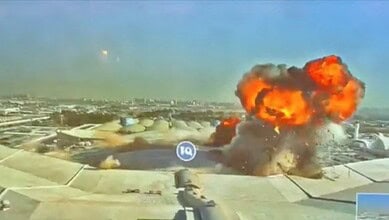Fire and smoke rise after a strike at Kuwait International Airport.