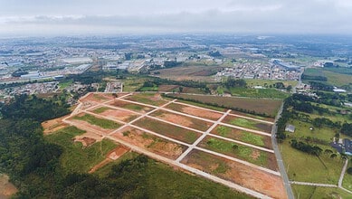 Aerial view of a developing residential area with cleared plots and roads in KPHB, Hyderabad.