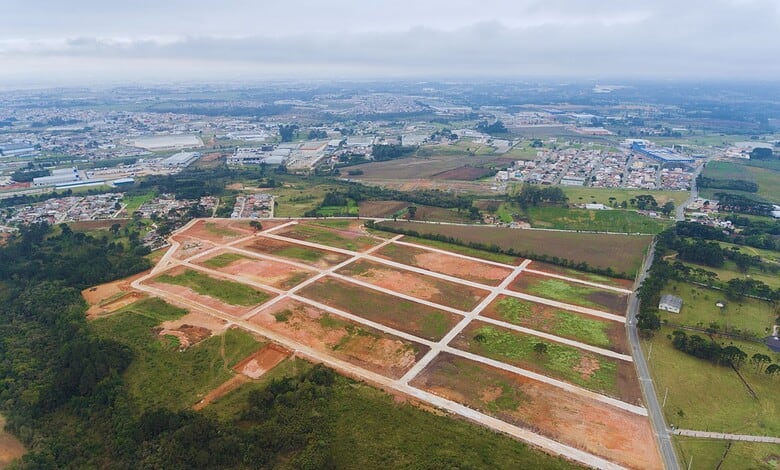 Aerial view of a developing residential area with cleared plots and roads in KPHB, Hyderabad.