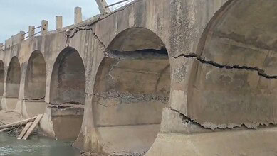 Close-up of cracks in the concrete arches of a 40-year-old bridge in Chitradurga.