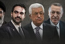 Four Iranian political leaders standing together against a dark background.
