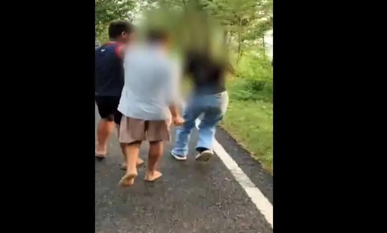 Group of individuals standing and walking on a road in Bihar, some with blurred faces.