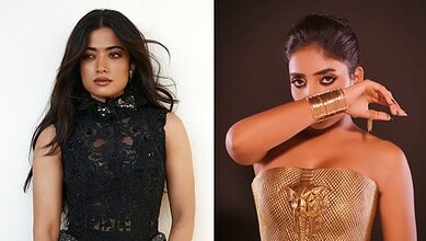 Two women posing, one in a black lace dress, the other in a gold strapless outfit with gold accessories.