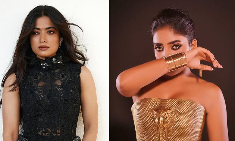 Two women posing, one in a black lace dress, the other in a gold strapless outfit with gold accessories.
