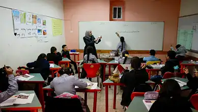 Classroom scene with Palestinian students and teachers in Jerusalem, engaging in learning activities.