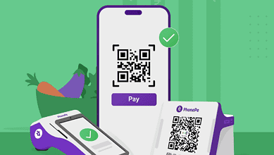 Smartphone displaying PhonePe QR code for digital payment with a checkmark.