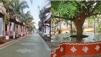 Traditional street scene with palm trees and decorated houses in a rural area of India.