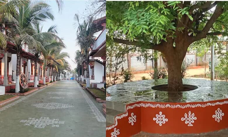 Traditional street scene with palm trees and decorated houses in a rural area of India.