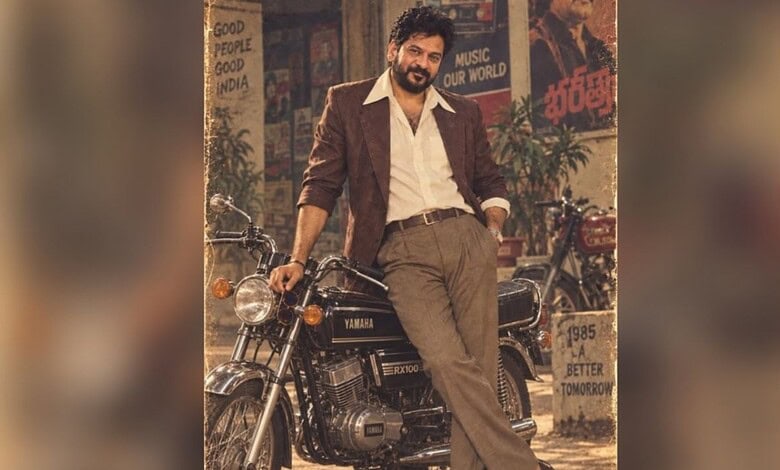 Revanth Reddy in 1980s style outfit with vintage motorcycle in a retro-themed setting.