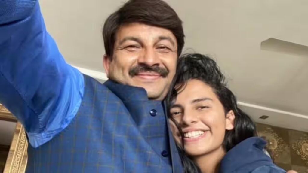 A man and a young girl smiling for a selfie, both wearing blue jackets.