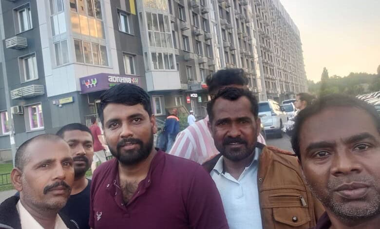 Group of Telangana residents on Russian battlefield, diverse men in urban setting.
