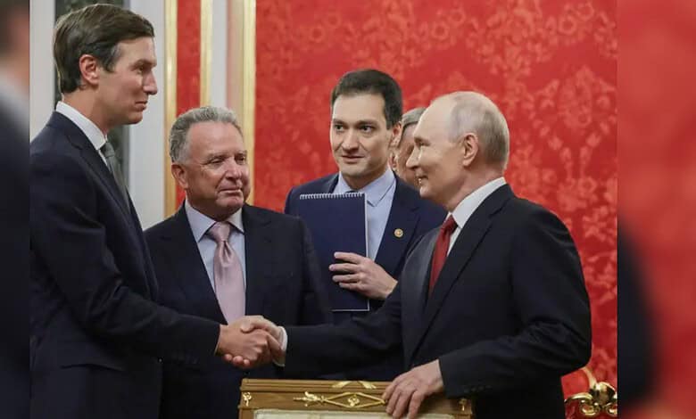 Four men in formal suits shaking hands and exchanging pleasantries in a red and gold decorated room.