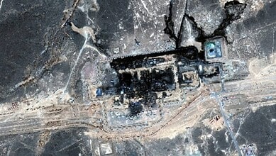 Burnt pipeline with visible damage and surrounding scorched earth in an industrial area.