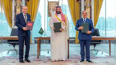 Leaders from Saudi Arabia, Pakistan, and Turkiye hold documents after signing defence agreements.