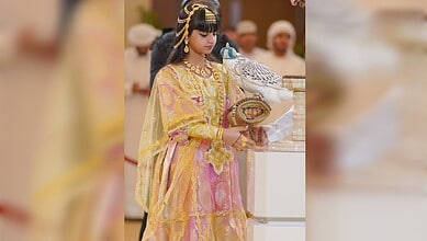 Shaikha Al Mansoori holds a rare white falcon at ADIHEX 2026 in Abu Dhabi.