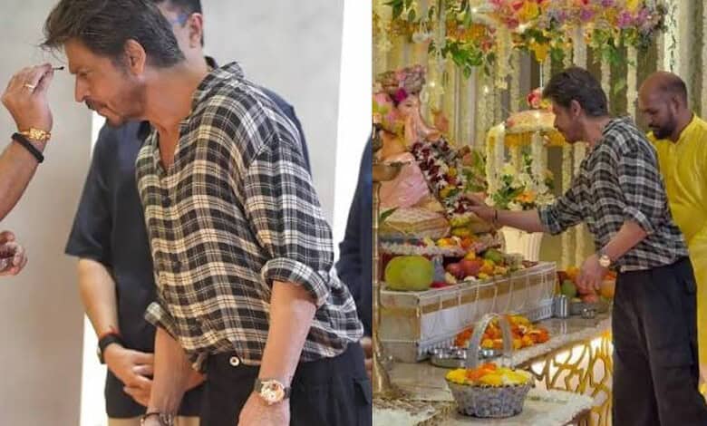 Shah Rukh Khan at a religious ceremony wearing a checkered shirt and a gold watch.
