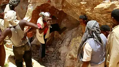 Group of rescue workers and villagers at the site of a gold mine collapse in Sudan.